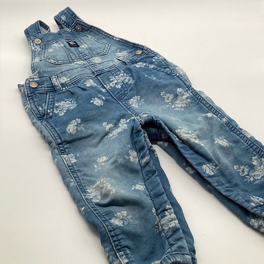 OshKosh B'gosh baby girl's floral knit denim overalls.